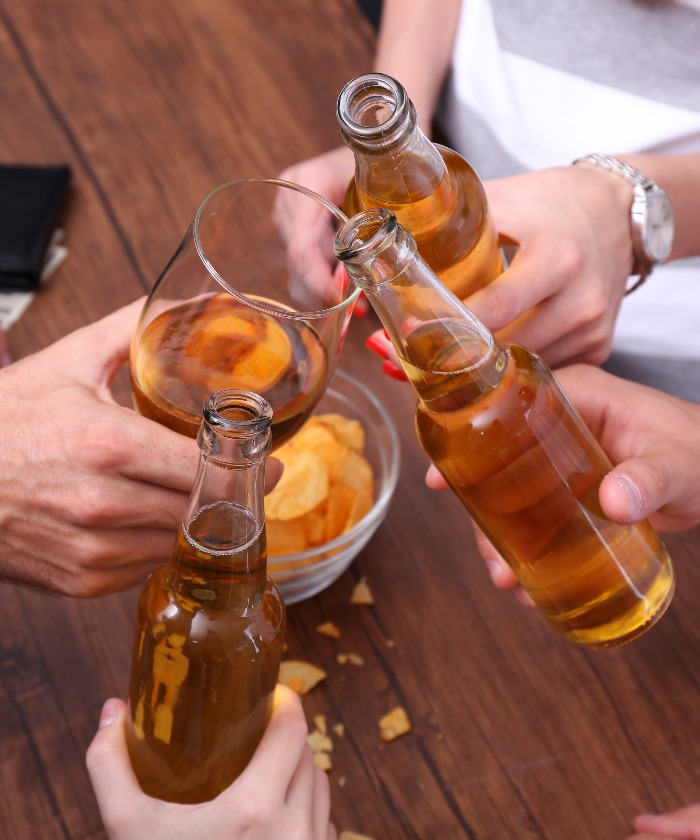 View on friends having alcoholic drinks in the bar, close-up